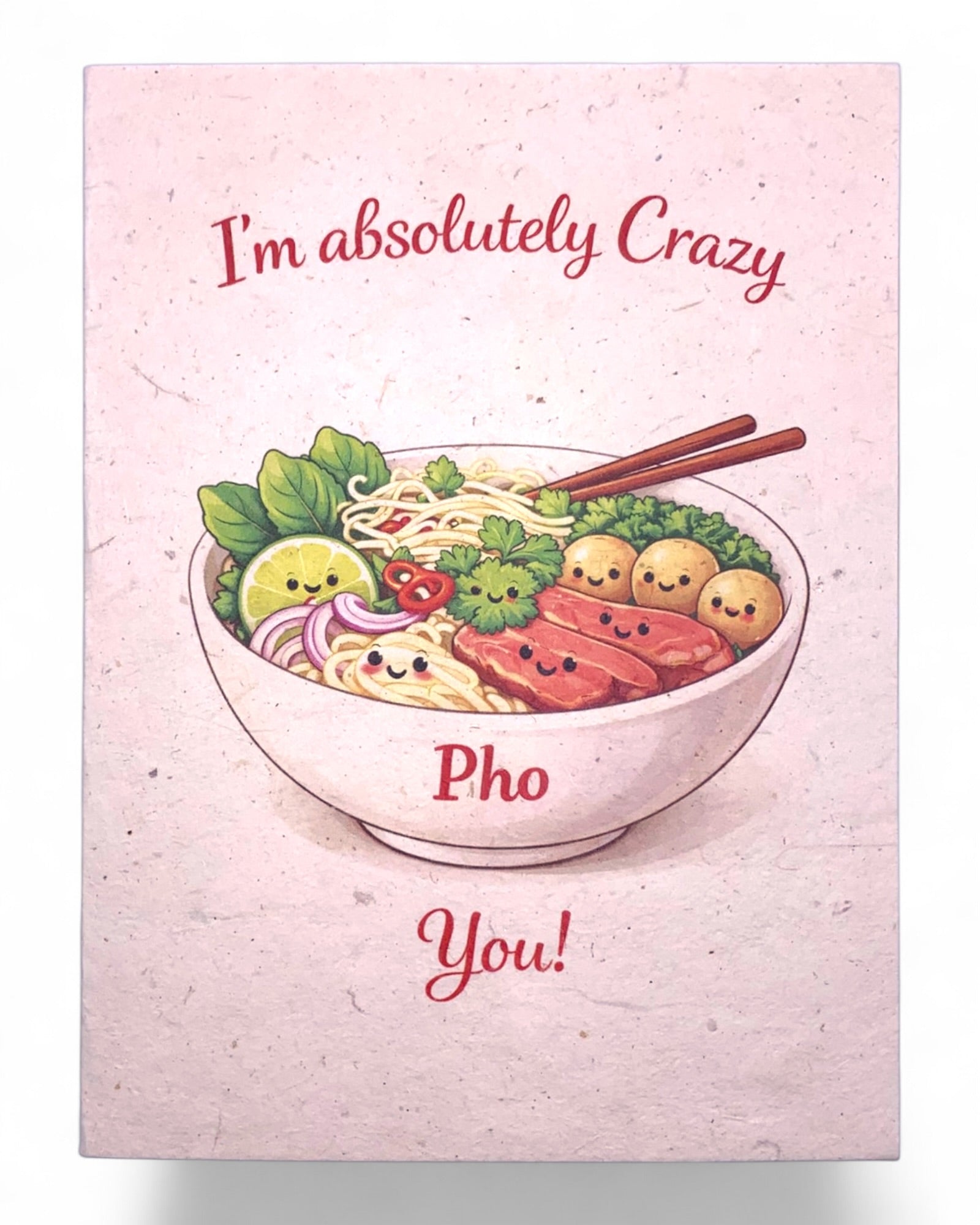 Card with a bowl of pho and cartoon vegetables on a pink background with text 'I'm absolutely crazy Pho You!'.