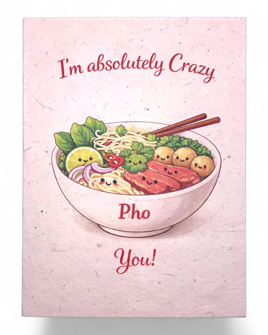 Card with a bowl of pho and cartoon vegetables on a pink background with text 'I'm absolutely crazy Pho You!'.