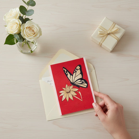 Lokta Cards red greeting card with hand-carved butterfly and flower design. Made from sustainable Lokta paper.